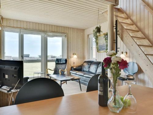 a living room with a table and a couch at Holiday Home Wilmar - 380m from the sea by Interhome in Nabbe