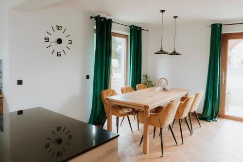 a dining room with a wooden table and chairs at Chata Stromček in Zuberec