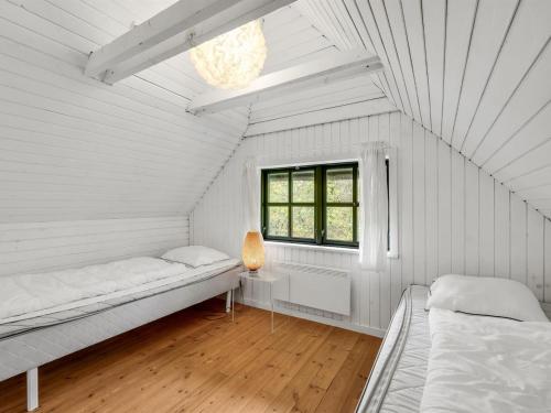 a white room with two beds and a window at Holiday Home Matilda - 1-6km from the sea by Interhome in Ulfborg