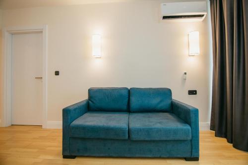 a blue couch sitting in a living room at Batumi River Source in Batumi