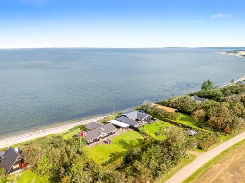 an aerial view of a house by the water at Holiday Home Næwe - 10m to the inlet by Interhome in Roslev