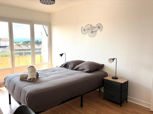 a bedroom with a bed and a large window at Le Valentine, Calme & Lumineux, proche centre in Valence