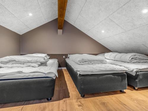 two beds in a room with a attic at Holiday Home Sönke - 4km from the sea by Interhome in Tagholm