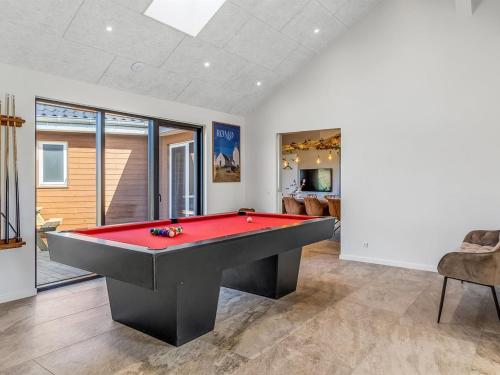 a billiard room with a red pool table at Holiday Home Sönke - 4km from the sea by Interhome in Tagholm
