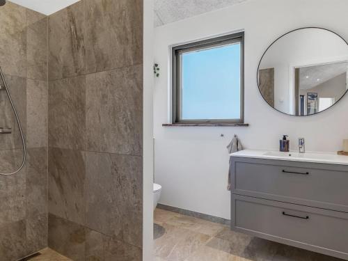 a bathroom with a sink and a mirror at Holiday Home Sönke - 4km from the sea by Interhome in Tagholm