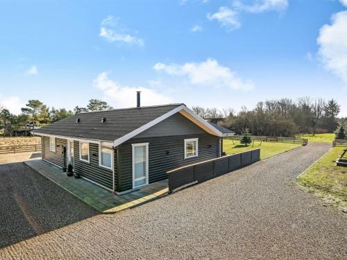 a small house on a gravel road at Holiday Home Elisaveta - 400m to the fjord by Interhome in Vemb