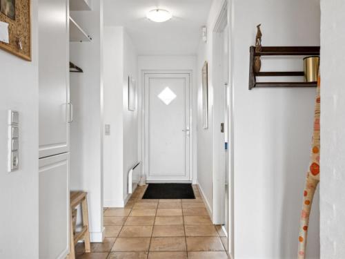 a hallway with white walls and a white door at Holiday Home Sakari - 375m from the sea by Interhome in Bro