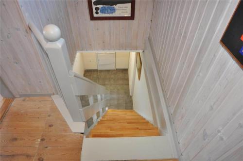 a staircase in a house with wooden floors and ceilings at 70282-Ulfborg-Kirkevej-2-A in Thorsminde
