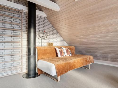a chair with pillows on it in a room at Apartment Annvy - 1km from the sea by Interhome in Neksø