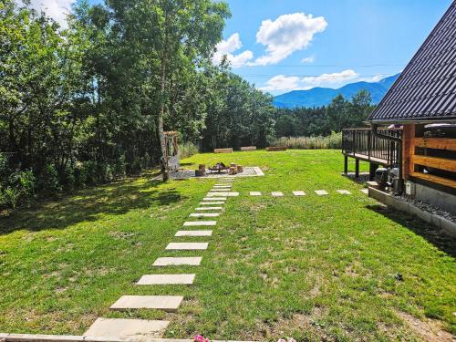a backyard with a stone pathway in the grass at Chalet Tomina Koliba Lika by Interhome in Lovinac