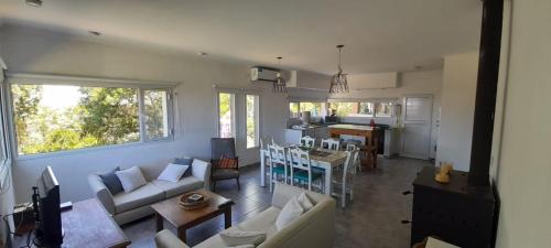 a living room with a couch and a table at Casa Bonita - Balneario RETA - alquiler temporario in Reta