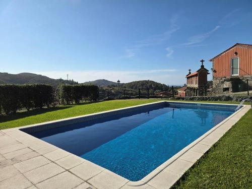 a swimming pool in the yard of a house at Casa dos Bernardos in Terras de Bouro