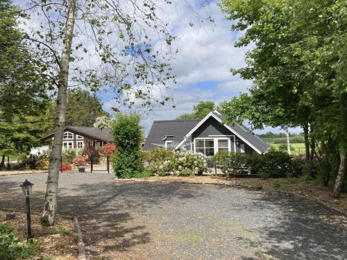 a house with a driveway in front of it at Holiday Home Adisl - 600m to the fjord by Interhome in Løgsted