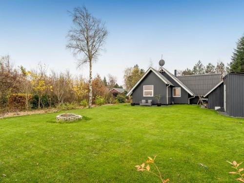 a house with a large yard with green grass at Holiday Home Adisl - 600m to the fjord by Interhome in Løgsted