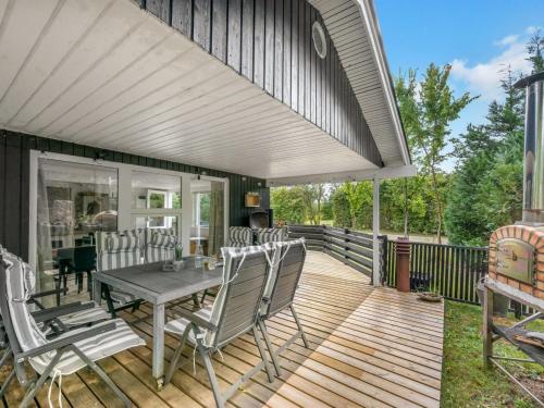 a patio with a table and chairs on a deck at Holiday Home Tiina - 500m to the fjord by Interhome in Tarm