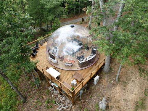 an overhead view of a domed building on a wooden deck at 1 of a kind! Largest Transparent Luxe Dome in USA! in Forks of Ivy