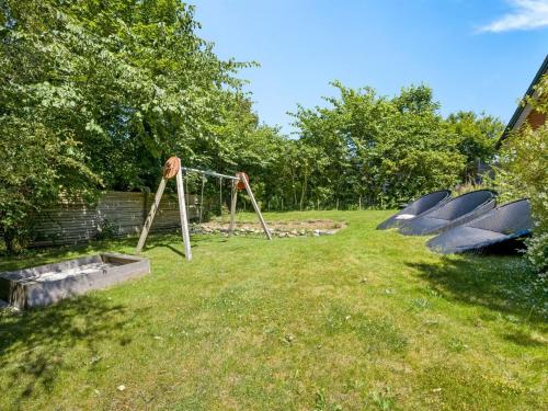 a group of boats in a yard with a playground at Holiday Home Solvey - 400m from the sea by Interhome in Sæby