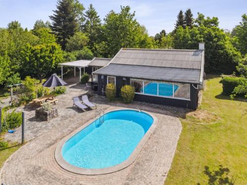 an overhead view of a swimming pool in front of a house at Holiday Home Elemine - 300m to the fjord by Interhome in Kirke-Hyllinge