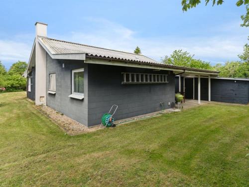 a house with a green lawn in front of it at Holiday Home Elemine - 300m to the fjord by Interhome in Kirke-Hyllinge