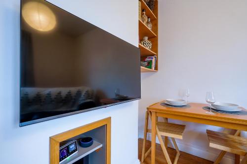 a living room with a fireplace and a table at Luxury 1st floor modern flat, close to city with free parking in Leeds