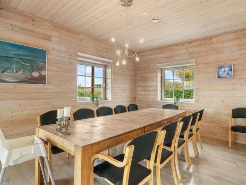 a dining room with a wooden table and chairs at Holiday Home Romy - 450m from the sea by Interhome in Bagenkop