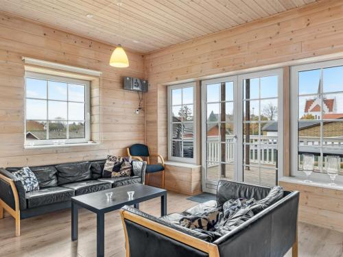 a living room with couches and a table at Holiday Home Romy - 450m from the sea by Interhome in Bagenkop