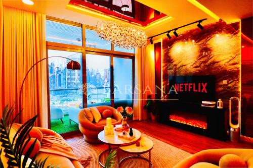 a living room with a couch and a fireplace at Barsana - Seaside Luxury 2BDR - Panoramic Marina & Sea Views in Dubai