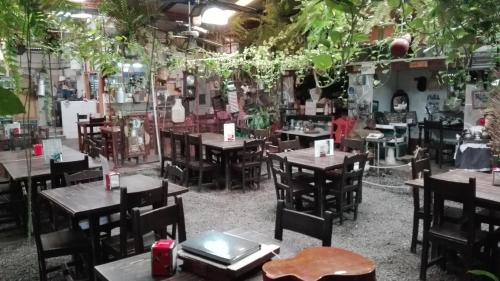 a restaurant with tables and chairs and plants at Hotel Playa de Arinaga in Arinaga
