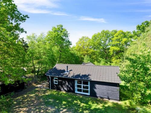 a small house in the middle of a yard at Holiday Home Tomine by Interhome in Give