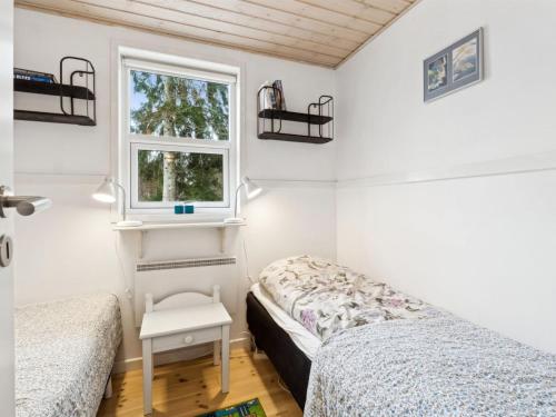 a bedroom with two beds and a window at Holiday Home Tomine by Interhome in Give