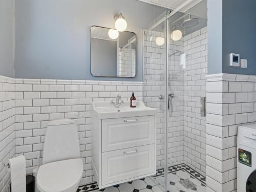 a white bathroom with a sink and a shower at Apartment Kate - 300m from the sea by Interhome in Allinge