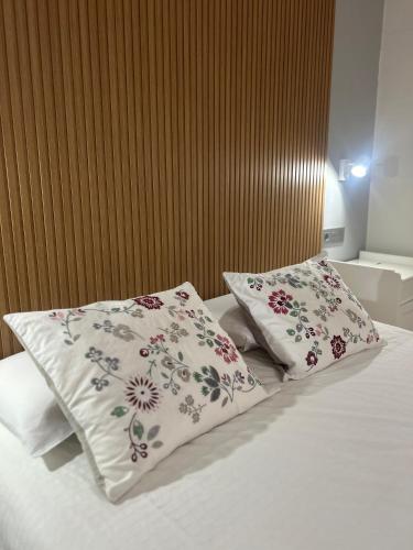 two pillows on top of a bed in a room at Villa El Cantil in Casillas de Morales
