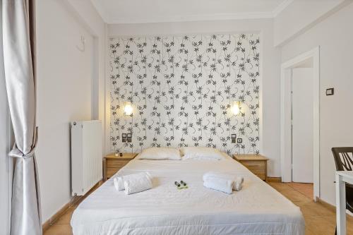 a bedroom with a white bed with two white towels at SALV3R Hotel in Athens