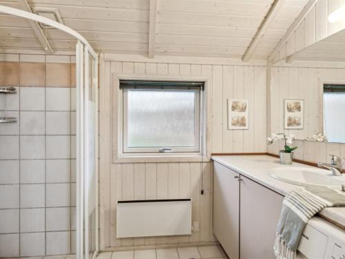 a bathroom with a sink and a window at Holiday Home Hjalmine - 225m from the sea by Interhome in Gørlev