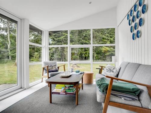 a living room with a couch and a table at Holiday Home Aija - 175m from the sea by Interhome in Strøby