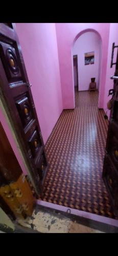 an empty room with purple walls and a room with a floor at 2BHK house in Tiruvannāmalai