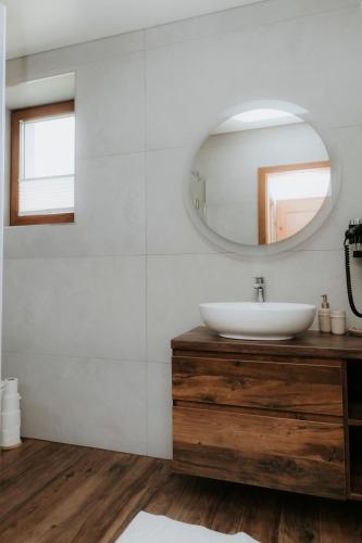 a bathroom with a sink and a mirror at Chata Stromček in Zuberec