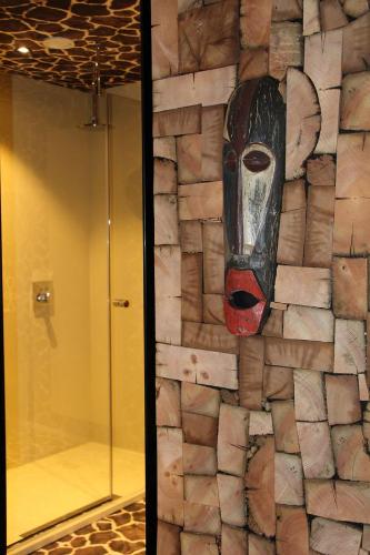 a wall with a painting of a face on it at Koto Garden Suites in Antwerp