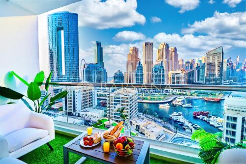 a living room with a view of a city skyline at Barsana - Seaside Luxury 2BDR - Panoramic Marina & Sea Views in Dubai