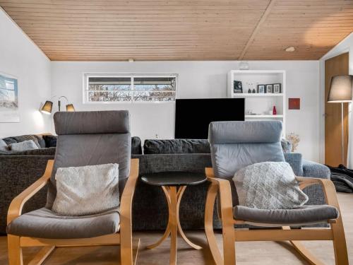 a living room with two chairs and a couch at Holiday Home Birla - 900m from the sea by Interhome in Hjørring