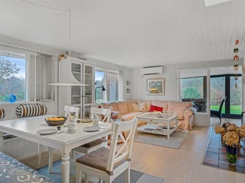a living room with a table and a couch at Holiday Home Sven - 250m to the fjord by Interhome in Højslev