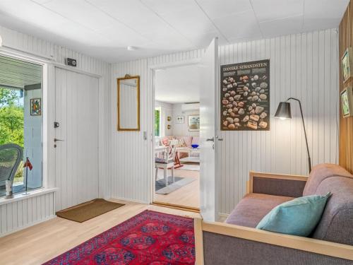 a living room with a couch and a table at Holiday Home Sven - 250m to the fjord by Interhome in Højslev
