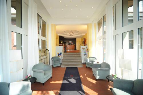 a hallway with chairs and a staircase in a building at Retro - Art - Hotel Lünen in Lünen