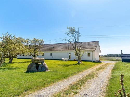 a building with two large rocks in front of it at Holiday Home Kora - 2km from the sea by Interhome in Læsø
