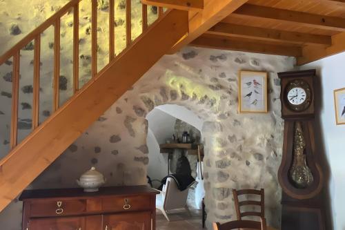 a room with a staircase and a clock on the wall at Maison en Provence ancien moulin in Entrepierres