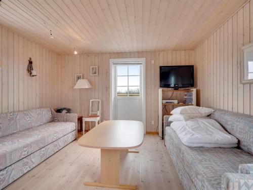 a living room with two couches and a tv at Holiday Home Ung - 650m to the fjord by Interhome in Struer