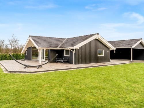 a house with a large deck in the yard at Holiday Home Antero - 500m to the fjord by Interhome in Spottrup