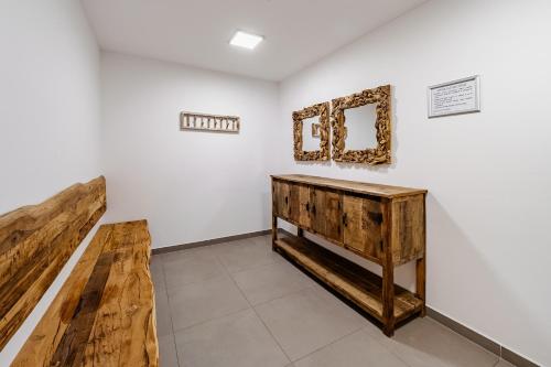a room with a table and a mirror on a wall at Wellness apartmán Pila Kvilda in Kvilda