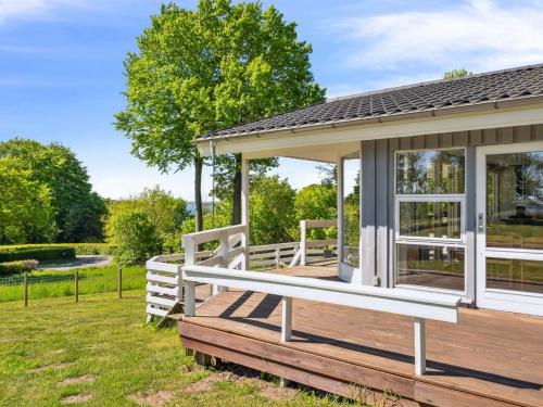 a wooden deck with a gazebo at Holiday Home Conradine - 600m from the sea by Interhome in Kruså