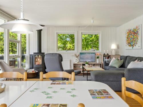 a living room with a couch and a table at Holiday Home Conradine - 600m from the sea by Interhome in Kruså